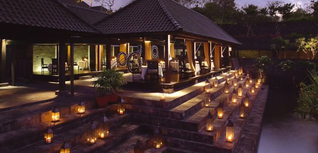 A candle-lit entrance to the signature fine dining at Bulgari Hotel Bali