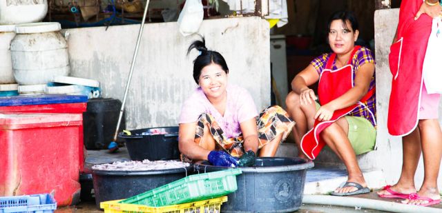 Fisherman's wife and daughter dealing with the today's catch, Koh Phangan, Thailand