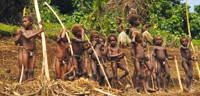 Young local children join in on the singing and dancing to entertain the land divers on Pentecost Island
