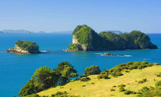 Coromandel town and its bay of green and blue hues, dotted with islands and capes.