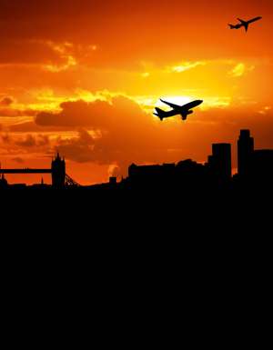 Jumbo jet flying over the London skyline.