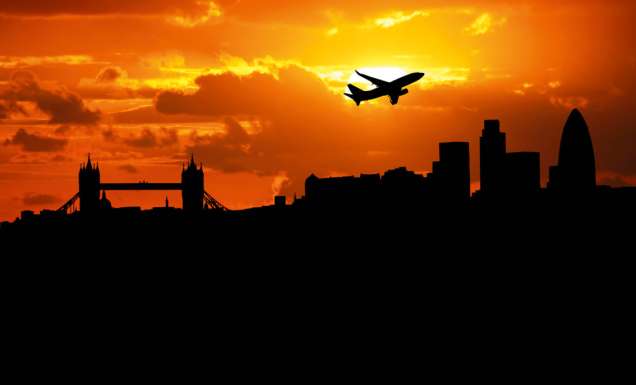 Jumbo jet flying over the London skyline.