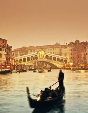 Sunset over the Grand Canal and the famous Rialto Bridge.