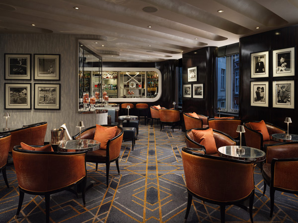 a dimly lit seating area at the American Bar at The Savoy Hotel London