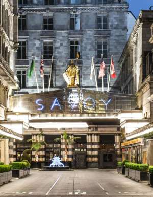 the entrance of The Savoy Hotel London at night