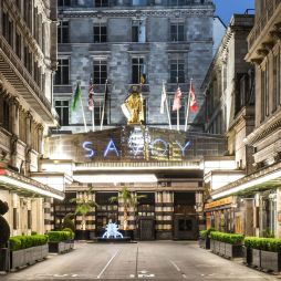 the entrance of The Savoy Hotel London at night