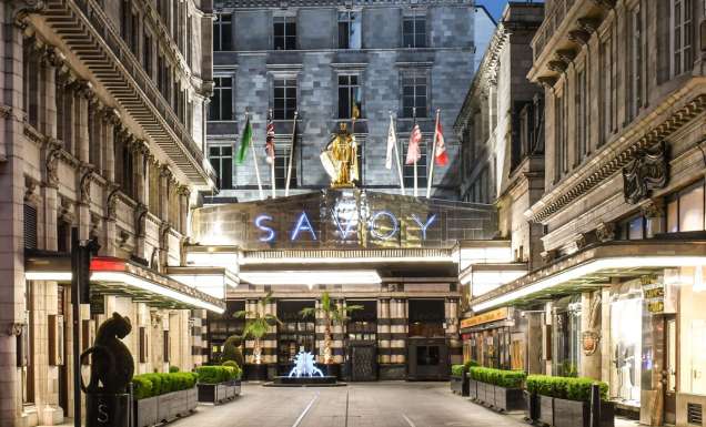 the entrance of The Savoy Hotel London at night