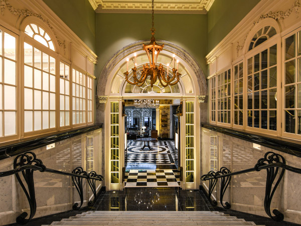 a chandelier hanging from a ceiling above the stairs of The Savoy London