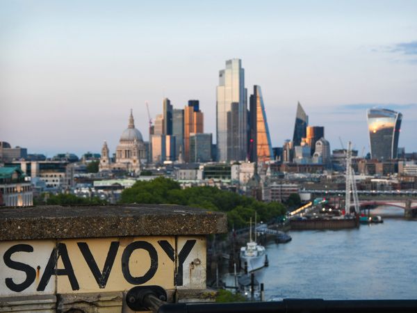 the Savoy sign by the edge of a river in London