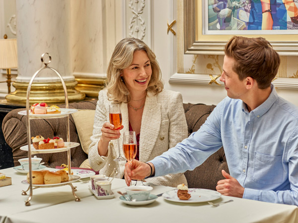 a couple enjoying high tea at the gazebo of The Savoy Hotel London