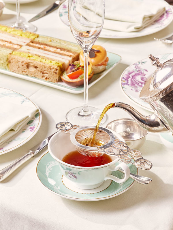 pouring tea into a cup at The Savoy Afternoon Tea
