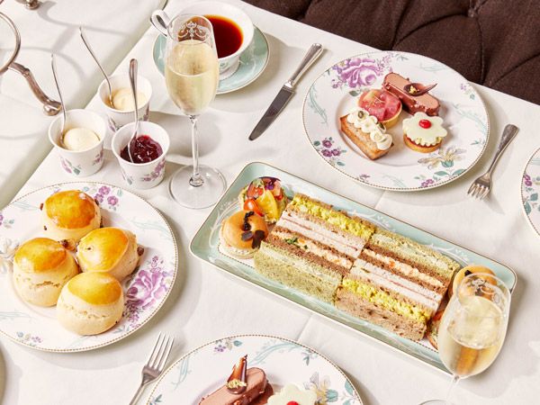 a spread of pastries and tea at The Savoy Afternoon Tea
