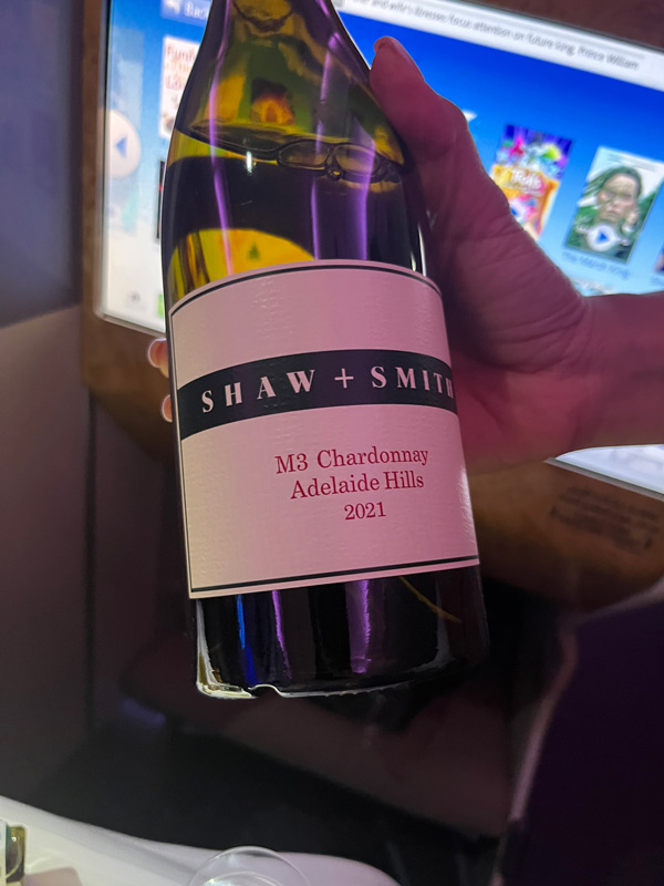 a hand holding a bottle of Shaw + Smith M3 Chardonnay