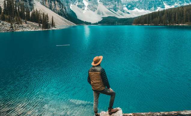 Man stands beside Moraine Lake