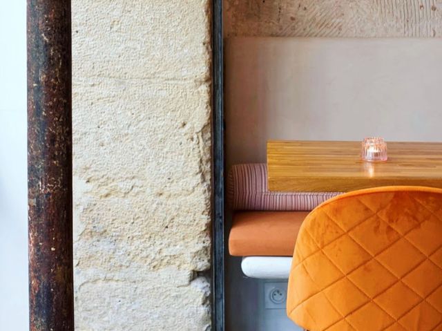 a vibrant orange velvet dining at Dirty Lemon, Paris