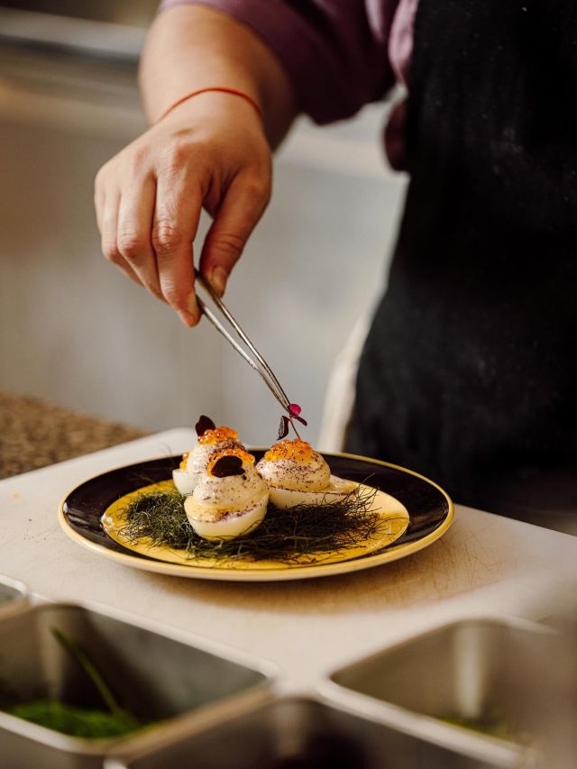 preparing a dish at Comptoir Club, Paris