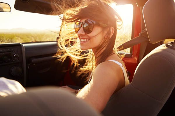 Lady in car with wind in hair