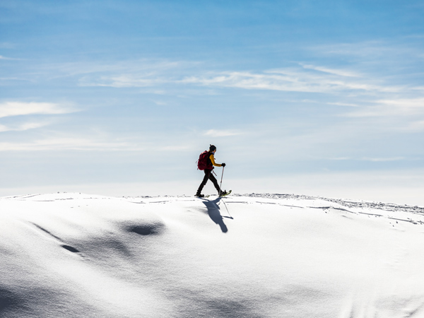 Woman snowshoeing on snow field