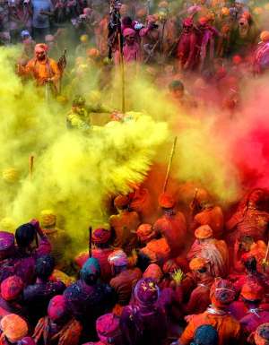 People celebrating in colour at the Holi Festival