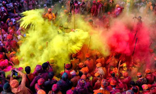 People celebrating in colour at the Holi Festival