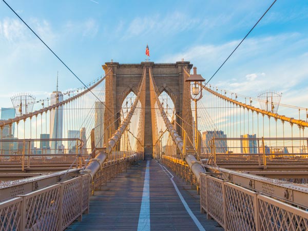 Stroll across the pedestrian walkway of the Brooklyn Bridge.