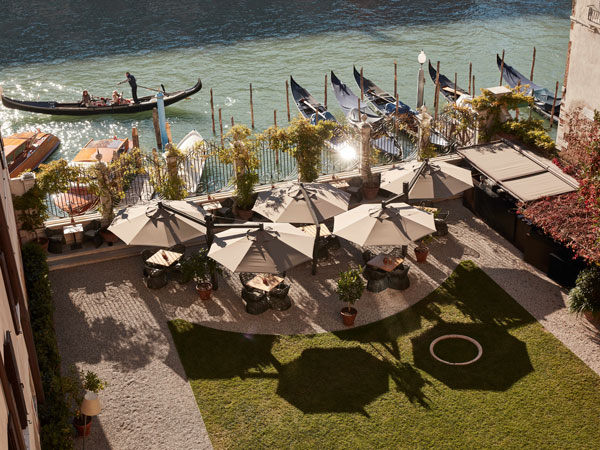 a drone shot of huge umbrellas on the Grand Canal at Aman Venice
