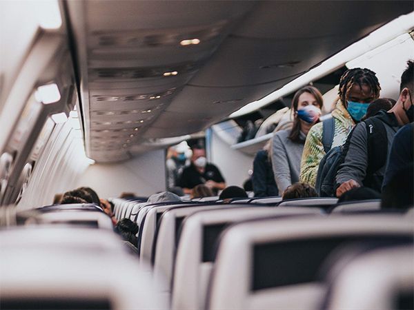 Face mask travellers on an airplane