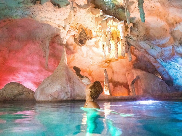 Woman swims in geothermal pools at The Lost Spring.