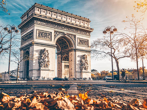 Arc de Triomphe located in Paris, in autumn scenery.