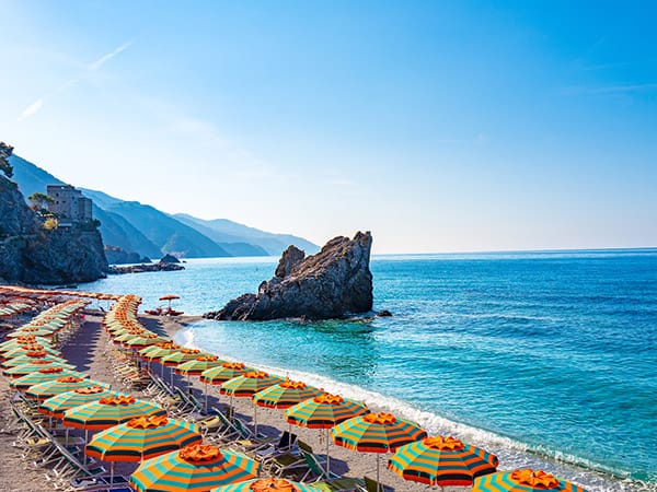 Monterosso beach with beach umbrellas and a view of the Ligurian Sea