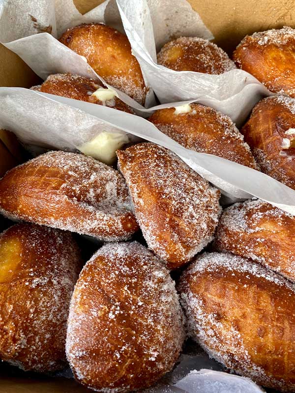 A box of fresh malasadas, Hawaiian delicacy