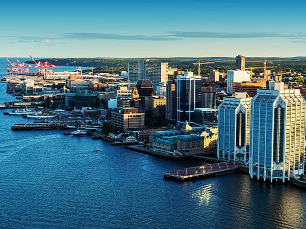 A low altitude aerial view of the Halifax skyline and waterfront in late evening