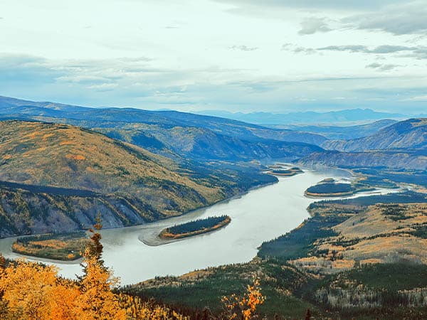 View over the mighty Yukon River from the Midnight Dome Lookout, located above the community of Dawson City, Canada