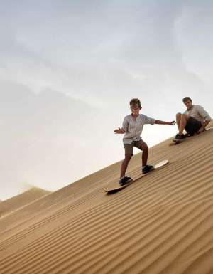 Family with child, Sandboarding in Dubai