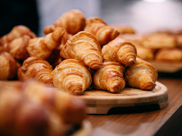 Rows of fresh baked French croissants ready to be sold