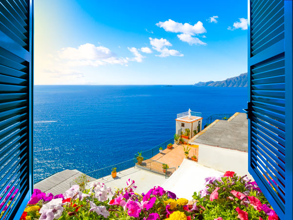 Scenic open window view of the Mediterranean Sea from a luxury resort room along the Amalfi Coast near Sorrento, Italy
