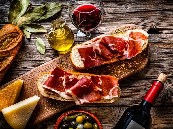 Spanish food Iberico ham sandwich, Spanish bocadillo de jamon Iberico and red wine