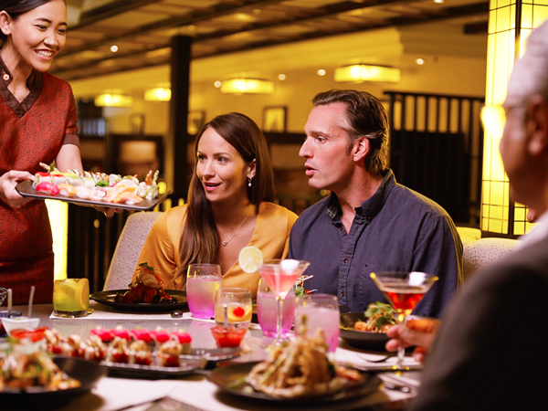 A family dining at Tamarind restaurant aboard a Holland America Cruise ship