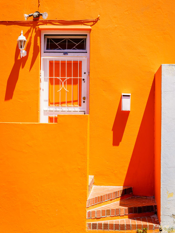 A bright orange wall in Bo Kaap, Cape Town, South Africa