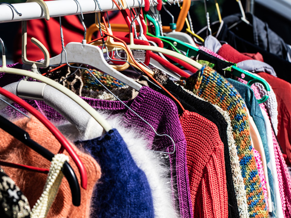 A rack of clothes in a thrift store
