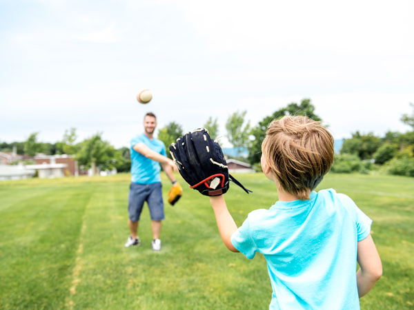 kid and dad playing baseball in San Diego