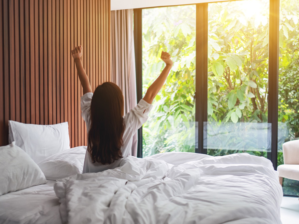 woman stretching with a beautiful outdoor view from the window