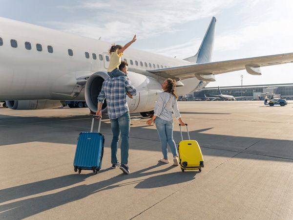 a happy family ready to board the plane