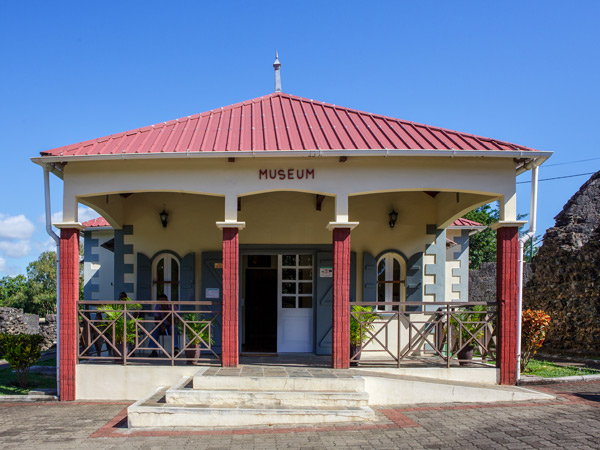 A white museum with a red roof. 