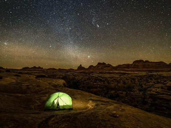 Lonely tent pitched under the stars at canyonlands National Park in Utah