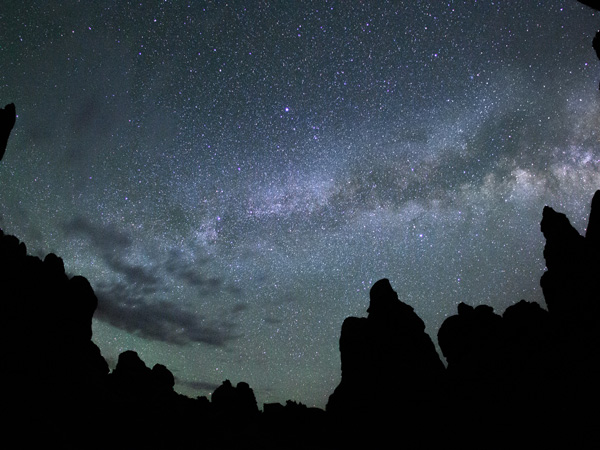 Starry sky behind rock formations at Canyonlands National Park in Utah