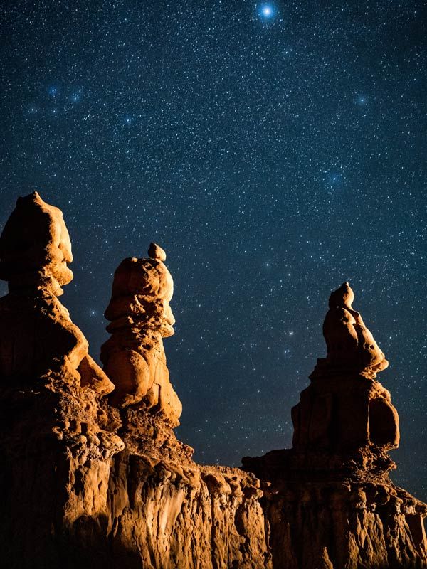Starry sky behind rock formations at Goblin Valley state park.