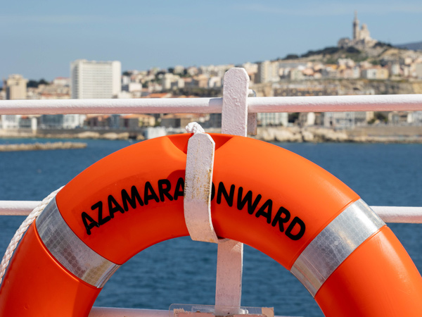 a lifebuoy hanging on the side railings of the Azamara Onward ship