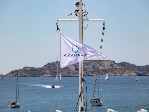 the Azamara flag waving as signal for its start of sailing