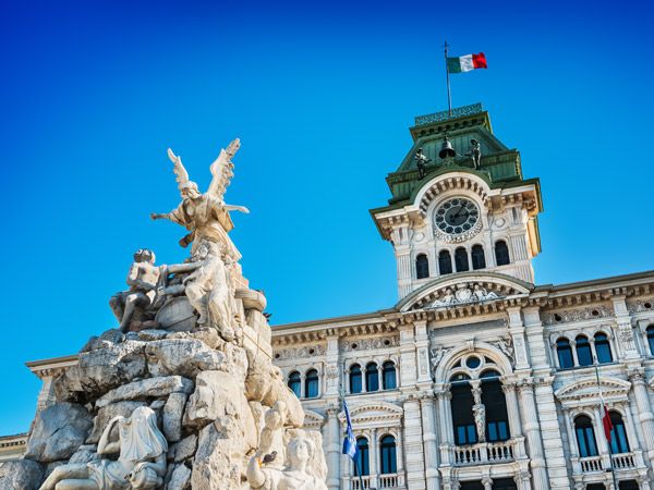 fountain and the Town Hall in Piazza Unità d'Italia (Unity of Italy Square) at the main square of the northern Italian city of Trieste